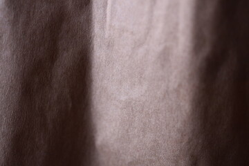 Poster - A cat sitting on a colorful curtain.