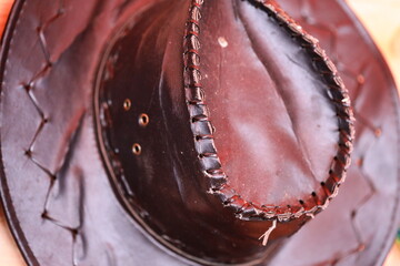 Poster - A close-up shot of a hat sitting on a table, perfect for use in editorial or commercial contexts.