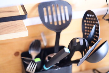 Poster - Container filled with various kitchen utensils.