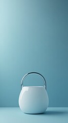 Poster - A white ceramic vessel has a metal handle on top