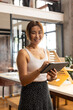 © Wavebreak Media - Smiling woman using digital tablet in modern office, embracing technology