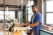 © Wavebreak Media - Smiling man in casual attire working on laptop at modern office desk, copy space