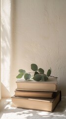 Aufkleber - Vintage books piled neatly catch warm sunlight filtering through a window, while fresh eucalyptus leaves add a touch of nature, inviting relaxation and contemplation
