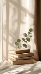 Aufkleber - Golden sunlight filters through sheer curtains, casting gentle shadows on a stack of vintage books. A sprig of eucalyptus adds a touch of nature, enhancing the tranquil atmosphere of the space