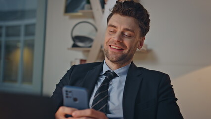 Poster - Joyful office worker messaging cellphone sitting office at evening closeup. 