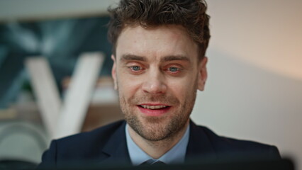 Poster - Excited businessman looking laptop screen anticipating success in office closeup