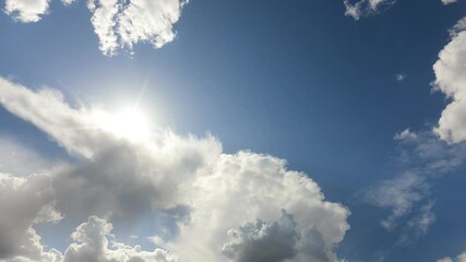 Wall Mural - beautiful fluffy white cumulus clouds in blue sky summer season. dramatic cloud covered bright sun s
