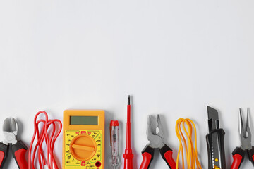 Poster - Different electrical tools on light background, flat lay. Space for text