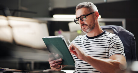 Fototapete - Browsing, night and man with tablet, office and creative for web design with software and stylus. Overtime, graphic designer and mature person with glasses in business, deadline and tech for project