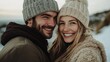 © SY - Happy young couple in winter hats are smiling outdoors. It could illustrate winter romance, love, or holidays.