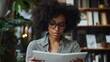 © Af - Focused Woman Reading in Library Setting