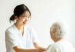 © Imaging L - Elderly care professional offering emotional and medical support to a senior citizen