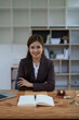 © Jirapong - female attorney advisor at a law firm reviews legal documents at her desk equipped with a laptop notebook and scales of justice in the office