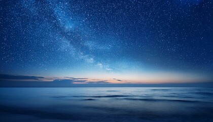 Wall Mural - starry night sky in blue hues above a serene ocean seascape with ample copy space image