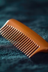 Poster - A simple wooden comb placed on a soft blue cloth, ready for use
