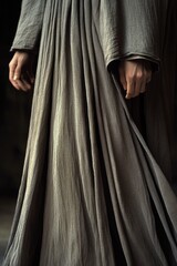 Poster - A woman wearing a long dress holds a cell phone, possibly checking her messages or making a call