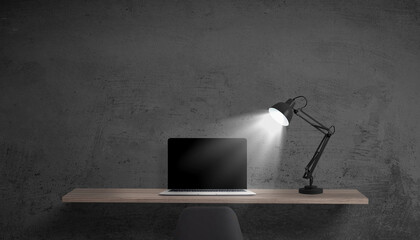 Poster - Dark workspace with laptop illuminated by desk lamp, blank screen ready for web or app promotion, black wall in the background for branding text