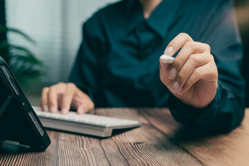Poster - Professional Person Using Tablet and Keyboard While Holding Stylus in Modern Workspace, Business concept