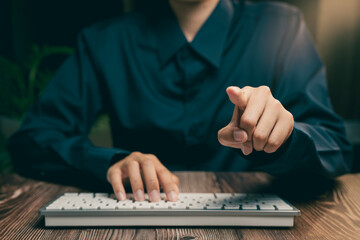Poster - Professional Focus on Keyboard with Hand Pointing in Modern Office Setting, Business concept