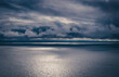 © Carla Tracy - Dark, dramatic, moody storm clouds brewing over the calm Irish Sea, with sunlight breaking through, the Welsh coast, view from The Great Orme, Llandudno, North Wales, UK
