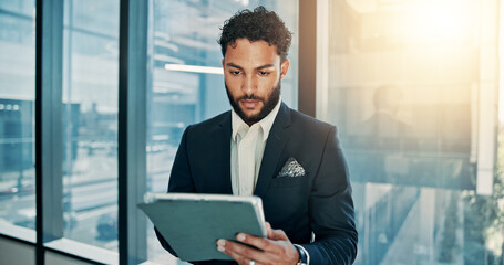 Fototapete - Tablet, research and businessman by window in office for company budget plan with connectivity. Digital technology, email and male financial manager with investment proposal for profit or revenue.