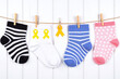 © He - row of colorful socks hanging on a clothes line