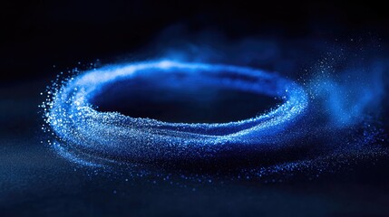 Poster - Vibrant blue powder swirls into a circular ring on a dark background, showcasing a minimalist and abstract design.