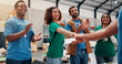© Jess B/peopleimages.com - Applause, handshake and success with volunteer team in warehouse together for aid, community or welfare. Charity, donation and support with people shaking hands for ngo or non profit agreement