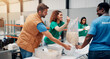 © Jess B/peopleimages.com - Volunteer, people and packing food for donation with community service, NGO outreach and charity event. Non profit project, teamwork and happy with oats parcel in warehouse for social responsibility