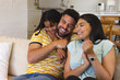 © Wavebreak Media - Happy family laughing together on cozy sofa at home, enjoying quality time
