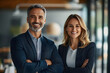 © Audrey - Two happy executives business man and woman partners in office. smiling company managers