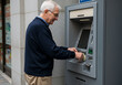 © Ozz - An older man is withdrawing money from an ATM in an urban setting, simplifying banking.