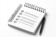 © Harsha - Spiral notepad with checklist and pen, ready for planning and task management.