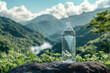 © Vilshanskyi - Clear water bottle set against a lush mountain landscape