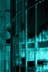 Poster - A glass fronted building structure with reflections abstract background in blue monochrome