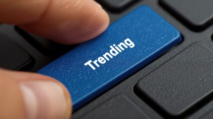 Poster - Close up Finger Pressing Blue Trending Button on Keyboard Modern Technology Concept