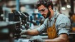 © Nirwasita - Man operating machinery wearing safety glasses and work apron
