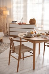 Poster - Stylish table setting with beautiful dishware and autumn decor in dining room