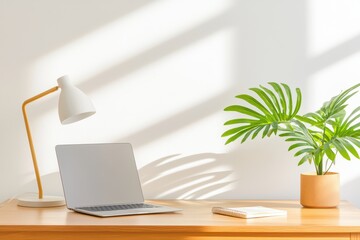 Poster - Modern Minimalist Office Desk Setup with Laptop and Green Plant on Wooden Surface