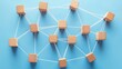 © Achmad Khoeron - Wooden blocks connected together on a blue background. Teamwork concept