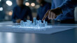 © Gun - Futuristic City Model with 3D Projection and Business Professionals Analyzing Urban Development