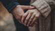 © Unic - Couple Holding Hands with Engagement Ring in Soft Focus Outdoor Setting with Muted Colors and Natural Light