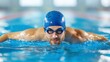 © FestiveMelodies - Man Swimming Freestyle in Pool with Swimming Cap and Goggles