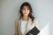 © kik - Confident Businesswoman Holding Tablet with Smile in Blazer