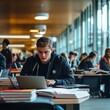 © Murad - Student Focused on Laptop Study Session in Modern Library with Books and Fellow Students Studying