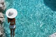 © Leo Rohmann - A woman in a white swimsuit standing at the edge of a luxurious swimming pool with clear blue water and enjoying a tranquil summer relaxation moment