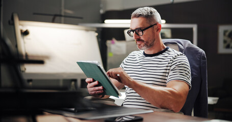 Aufkleber - Online, night and mature man with tablet, office and creative for web design with software or browsing. Overtime, graphic designer and person with glasses in business, deadline and tech for project