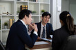 © Natee Meepian - Engagement and Legal Strategy. Lawyers collaborating on a case discussion.