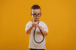 © standret - Playing doctor, with stethoscope. Cute little boy is against yellow background
