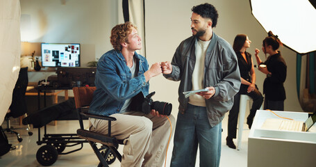 Poster - Fist bump, photography and teamwork with people in studio together for behind the scenes production. Getting ready, makeup or styling with director and photographer on set for success or target